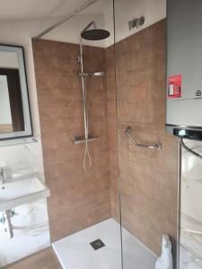 a shower with a glass door next to a sink at El Limonero de Alajar in Alájar +20 photos