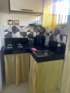 a kitchen with a sink and a counter top at Aconchegante Kitnet na sede Aracruz 1 km do centro individual ótima logística lugar tranquilo in Aracruz +22 photos