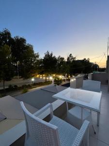a patio with a table and chairs on a roof at Lea home in Vlorë