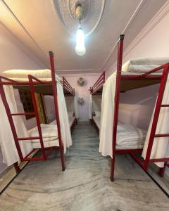 a hallway with three bunk beds in a room at Hostel The Dara in Jaisalmer