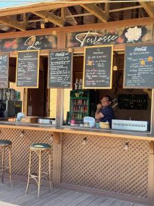 a man sitting at the counter of a restaurant at Paradise Azur in Saint-Raphaël