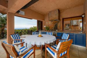 a kitchen and dining room with a table and chairs at San Lameer Villa 11703 - 5 Bedroom Luxury - 10 pax - San Lameer Rental Agency in Southbroom