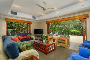 a living room with blue couches and a table at San Lameer Villa 11703 - 5 Bedroom Luxury - 10 pax - San Lameer Rental Agency in Southbroom