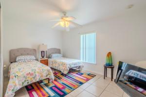 a bedroom with two beds and a ceiling fan at Flint and Kingscrest, LLC - Private Rooms in Shared Home in Orlando
