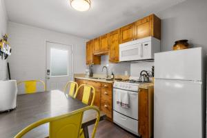 a kitchen with a table and a white refrigerator at Downtown Cozy Home Base - Purple Sage 3 in Moab
