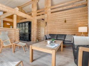a living room with a couch and a table at Holiday Home Edzard - 900m from the sea by Interhome in Marielyst