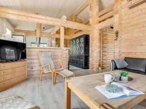a living room with a table and a fireplace at Holiday Home Edzard - 900m from the sea by Interhome in Marielyst