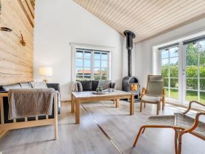 a living room with a couch and a fireplace at Holiday Home Edzard - 900m from the sea by Interhome in Marielyst