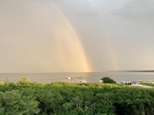 a rainbow over the water with a group of boats at Holiday Home Valia - 20m from the sea by Interhome in Sønder Stenderup