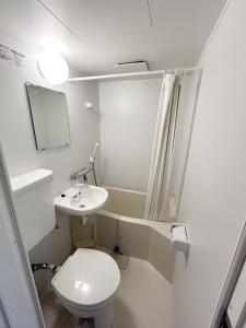 a small bathroom with a toilet and a sink at Shinjuku Center 新宿中心#Shinjuku kabukicho#3 min walk from subway##高速无限制网路#新装修高级公寓#大楼一层入口自动锁门Newly renovated#404 in Tokyo