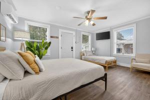 a bedroom with a bed and a ceiling fan at Unit 19 Tiny Haven Unwind in Pensacola in Pensacola