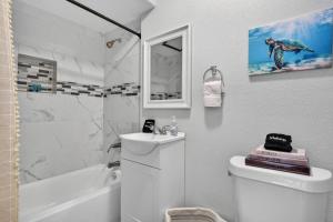 a bathroom with a toilet and a sink and a shower at Unit 19 Tiny Haven Unwind in Pensacola in Pensacola