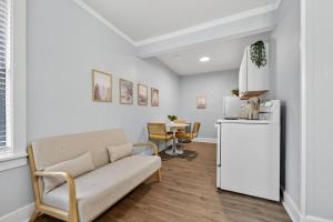 a living room with a couch and a table at Unit 19 Tiny Haven Unwind in Pensacola in Pensacola +6 photos