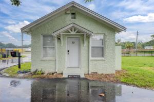 a small green house with a white door at Unit 19 Tiny Haven Unwind in Pensacola in Pensacola