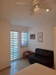 a living room with a black couch and a table at Milenio III B&B in Querétaro +42 photos