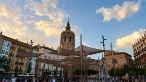 a building with a clock tower in a city at Cosy Rooms Embajador in Valencia +36 photos