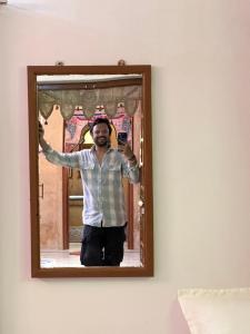 a man taking a picture of himself in a mirror at Hostel The Dara in Jaisalmer +2 photos