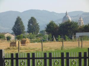 a fence in front of a field with hay at B&B La Gioiosa in Assisi