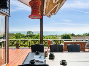 a patio with a table and chairs on a deck at Holiday Home Mariam - 100m from the sea by Interhome in Åkirkeby