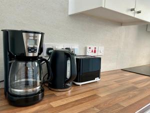 a coffeemaker and a coffee maker on a kitchen counter at Silver View Apartment in Polis Chrysochous