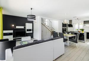 a living room and dining room with a couch and a table at Villa Rose in Kršan