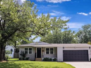 a white house with a tree and a garage at Flamingo Ln House - Peloton EV Chrgr 3-Bedr 2-Bath in Dallas