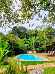 a swimming pool in the yard of a house at Vila Pitanga Trancoso in Trancoso