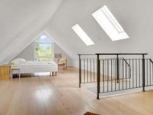 a bedroom with a bed in a attic at Holiday Home Anelle - 2-5km from the sea by Interhome in Blokhus