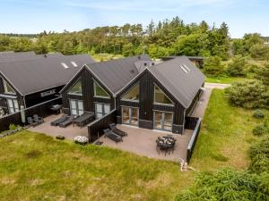 an aerial view of a home with a black roof at Holiday Home Anelle - 2-5km from the sea by Interhome in Blokhus