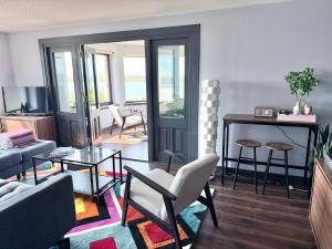 a living room with a couch and a table at Vestley Banks in Orkney