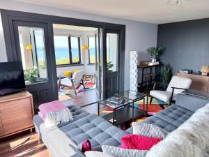 a living room with a couch and a television at Vestley Banks in Orkney