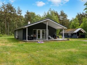 a black house with a large yard at Holiday Home Bæver - 1km from the sea by Interhome in Læsø