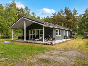a small house with a porch and a deck at Holiday Home Bæver - 1km from the sea by Interhome in Læsø +17 photos