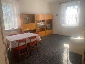 a dining room with a table and chairs in a room at Apartment in Kietrz