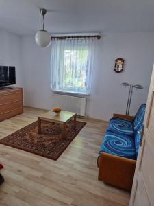 a living room with a couch and a coffee table at Apartment in Kietrz