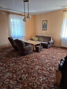 a living room with two couches and a table at Apartment in Kietrz