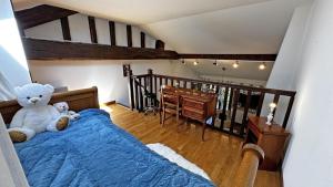 two teddy bears sitting on a bed in a bedroom at Fayollas in Bussière-Galant +28 photos