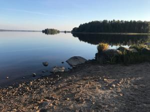 a view of a lake with trees in the distance at Spacious accommodation, close to nature and attractions in Alvesta