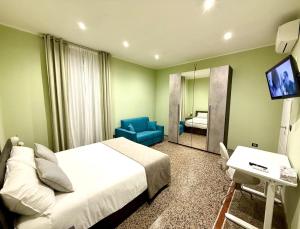 a bedroom with a bed and a mirror and a television at Casa B&B Paganini -If you book 2 rooms you have the whole house to yourself in Savona