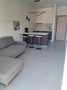 a living room with a couch and a kitchen at Sea View Potidaia in Nea Potidaea +1 photo