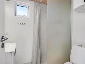 a bathroom with a white door and a sink at Holiday Home Brun - 900m from the sea by Interhome in Marielyst