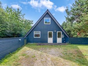 a blue house with a black roof at Holiday Home Hannele - 10km from the sea by Interhome in Oksbøl