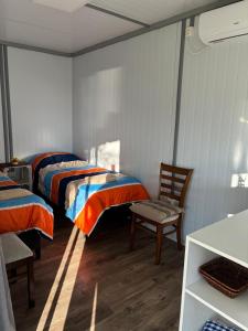 a bedroom with two beds and a chair in it at La Martinna 3 in Trinidad