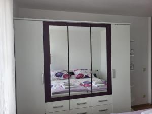 a large white cabinet with a bed in it at Ferienwohnung Kris in Leipzig