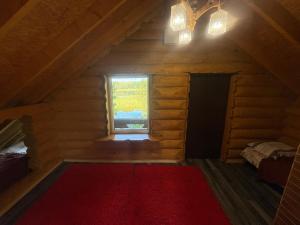 a room with a red rug in a room with a window at Guest House Väikesaare in Narva