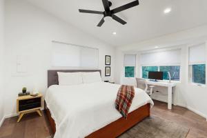 a bedroom with a bed and a desk and a ceiling fan at Rio Lindo River Retreat in Healdsburg