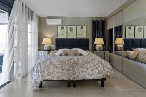 a bedroom with a large bed and two lamps at Villa Blanca in Case-Pilote +45 photos