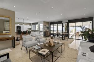 a living room with a couch and a table at Villa Blanca in Case-Pilote