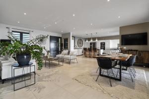 a living room and dining room with a table and chairs at Villa Blanca in Case-Pilote