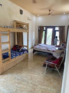 a bedroom with two bunk beds and a window at View Point Stay in Yelagiri